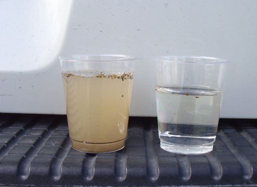 Side-by-side cups: untreated South Basin water vs APS-treated clear water
