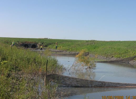 Floc catchment nets and channel down-gradient of twin discharge pipes