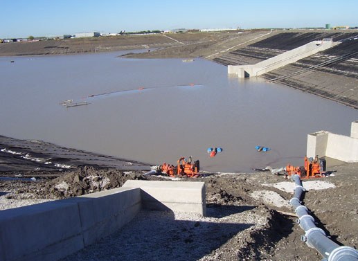 Large O'Hare South Basin with sediment-laden water and pump equipment