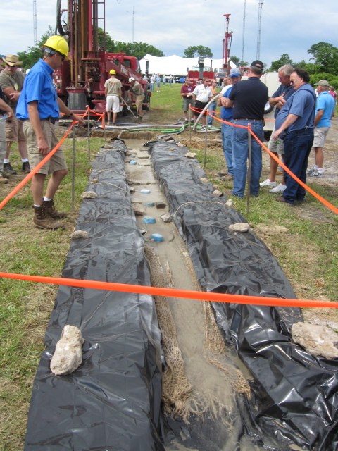 Plastic-lined mixing ditch with APS Floc Logs during geothermal drilling demo